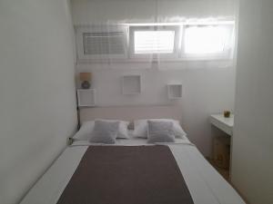 Postel nebo postele na pokoji v ubytování Apartmani NIKA
