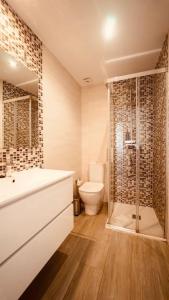 a bathroom with a shower and a sink and a toilet at Torre de la Vela 2 in Granada