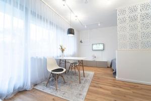 a dining room with a table and two chairs at Apartment mit Schwimmbad und Privatparkplatz in Augsburg