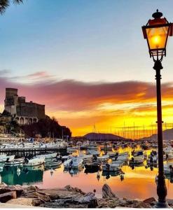 a street light next to a harbor with boats at Rebecca House in La Spezia