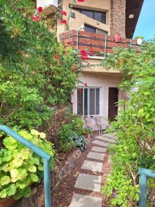 a pathway leading up to a building with flowers at Dekel in Arad