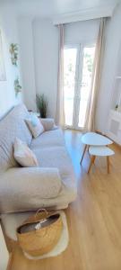 uma sala de estar com um sofá e uma mesa em Apartamento Hermosilla em Málaga