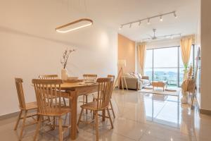 a dining room and living room with a table and chairs at Serene Muji Family Cottage(2-7pax) & Sunrise View in Cameron Highlands