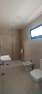 a bathroom with a toilet and a tub and a sink at APARTAMENTO TURISTICO EN LEBRIJA in Lebrija +5 photos
