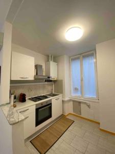a kitchen with white cabinets and a stove top oven at Appartamento Profumo di Mare in Camogli