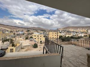 a view of a city from the balcony of a building at Petra balcony apartment in Wadi Musa