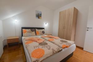 a bedroom with a bed with pillows on it at Capitol Apartmani in Vrnjačka Banja