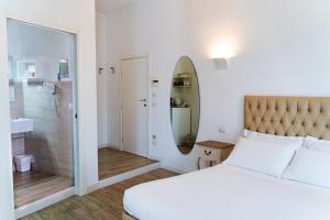 a bedroom with a large bed and a bathroom at Residence Le Vie del Centro in Matera