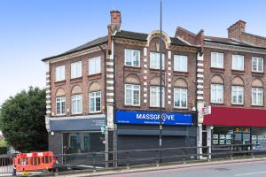 a large brick building with a sign that reads massage eye at Single Studio Flat in London