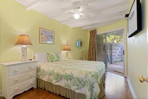 a bedroom with a bed and a ceiling fan at East Beach Villa Unit 204 in East End