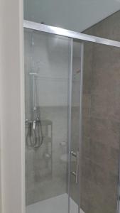 a shower with a glass door in a bathroom at SAN FELIPE in Carmona