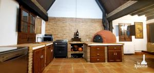 a large kitchen with a stove and an oven at La Kasona del mirador in Córdoba