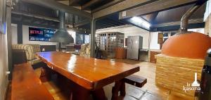 a large wooden table in a room with a kitchen at La Kasona del mirador in Córdoba