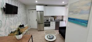a kitchen with a refrigerator and a table in a room at Estudio independiente Forget Me Not in Getxo
