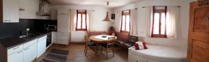 a kitchen with a table and a dining room at Ferienhaus Obermoser in Sankt Johann im Pongau