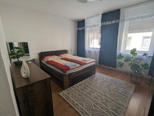 a bedroom with a bed and a desk and a table at Ferienwohnung Nina direkt in Zentrum in Bad Wildbad