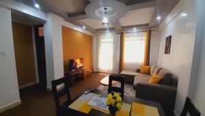 a living room with a couch and a table at Hotfoot Homestay in Nanyuki