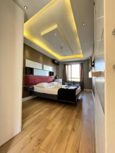 a large bedroom with a large bed and a ceiling at The Sisli Luxury Corner Suit in Istanbul