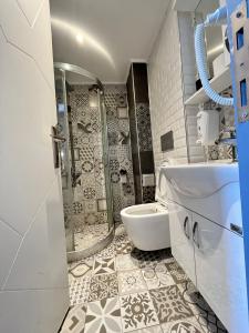 a bathroom with a shower and a sink and a toilet at The Sisli Luxury Corner Suit in Istanbul