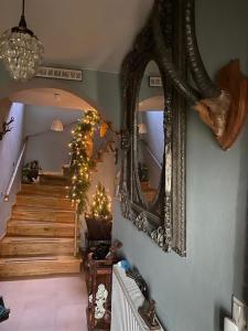 a room with a staircase with a mirror and a christmas tree at Pölstaler Berghütte in Oberzeiring