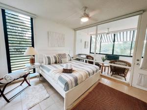 a bedroom with a bed and a table and chairs at Beach Village Comfy & Cozy Apt Palmas Del Mar 73 in Buena Vista