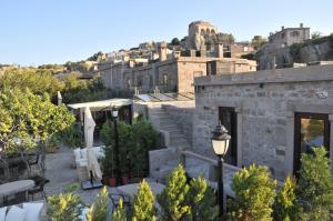 a building with a street light and a city at Assosyal Hotel in Behramkale