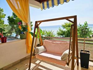 a porch swing with a view of the ocean at Apartments Tempera by the beach in Split
