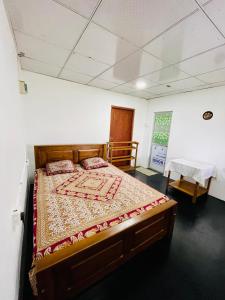 sypialnia z drewnianym łóżkiem w pokoju w obiekcie Lucky Lodge w mieście Koggala