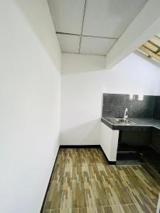 a bathroom with a sink and a wooden floor at Lucky Lodge in Koggala