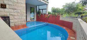 a swimming pool in front of a house at GKH A-2 by Asri Kusuma Villa in Batu +5 photos