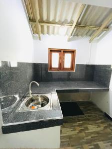 a kitchen with a sink and a counter top at Lucky Lodge in Koggala