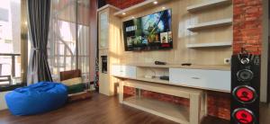 a living room with a tv and a fireplace at GKH A-2 by Asri Kusuma Villa in Batu