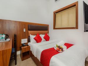 a hotel room with two beds and a bowl of fruit at Hotel Zillion Executive - Kurla West Mumbai in Mumbai