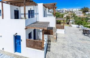 una casa con una puerta azul en una calle en Almiriki Serifos, en Livadakia