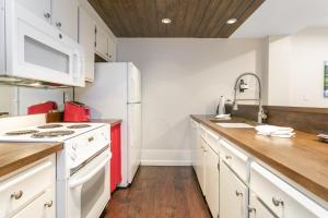 een keuken met witte kasten en een rode koelkast bij 303 Fallridge Condominiums condo in Vail