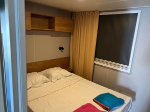 a small bedroom with a bed with a window at JP - L'Eleganzia 2 ch, clim réversible, Confort et Elégance, in Lattes +19 photos