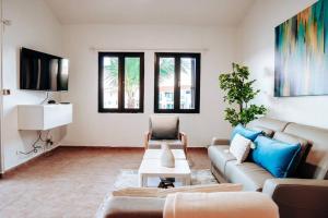 a living room with a couch and a table at Hidden Gem @ Palmas Del Mar w/ View of Marina 999 in Humacao