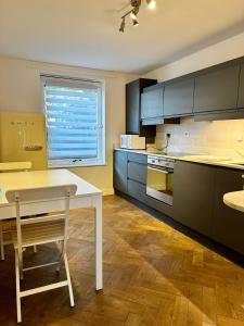 a kitchen with a white table and a window at Gero's One Bedroom apartment London NW8 in London