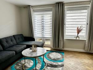 a living room with a couch and a table at Gero's One Bedroom apartment London NW8 in London
