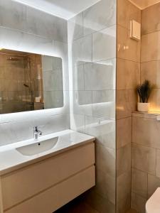 a white bathroom with a sink and a mirror at Gero's One Bedroom apartment London NW8 in London