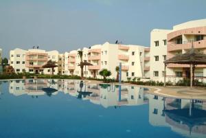 a large pool in front of some apartment buildings at MOHAMMEDIA 55 in Mohammedia