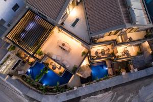 an overhead view of a house with a pool at night at Opal Executive Suites in Nafplio