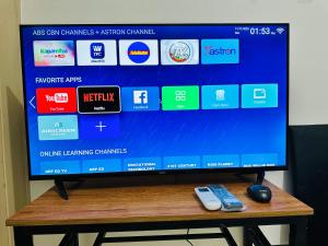 a television sitting on a table with a remote control at Sea Residences Tower F Angel in Manila