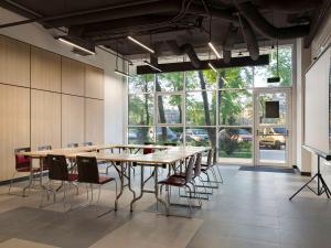 a large conference room with a large table and chairs at Adagio Kyiv Beresteiska in Kyiv