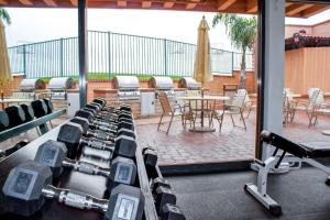 a gym with rows of dumbbells and a patio at Hilton Vacation Club San Luis Bay Avila Beach in Avila Beach