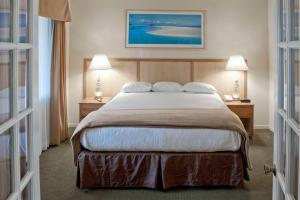 a bedroom with a large bed with two tables and two lamps at Hilton Vacation Club San Luis Bay Avila Beach in Avila Beach +25 photos