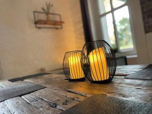 two lamps sitting on top of a wooden table at Villa Ambiente Falkensee in Falkensee