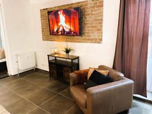 a living room with a couch and a fireplace at Villa Ambiente Falkensee in Falkensee