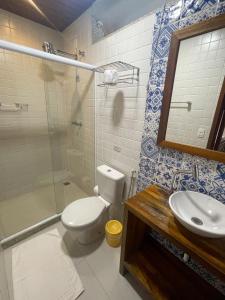 a bathroom with a toilet and a sink and a shower at Pousada Albatroz in Abraão