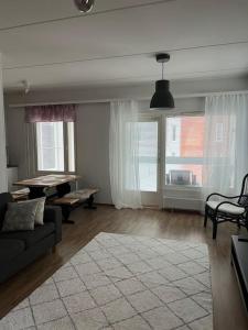 a living room with a couch and a piano at Apartment Korsholma2 in Vaasa